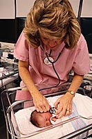 Picture of a physician listening to a newborn