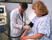 Picture of a doctor taking a woman's blood pressure