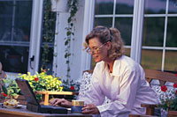 Picture of a woman, outdoors, using a computer