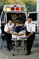 Picture of EMTs carrying a patient on a gurney