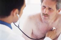Photo of a doctor listening to male patient’s heart